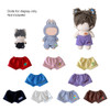 A selection of plush doll shorts in various colours, including blue, purple, white, and grey, with a display of dolls.