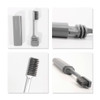A foldable toothbrush in grey, showcasing its compact design and storage case. Features a brush head and handle.