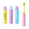 A foldable soft bristle toothbrush in pink, yellow, blue, and purple cases, each featuring a logo.