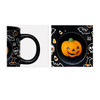 A black ceramic coffee mug featuring Halloween-themed designs and a custom spinner toy shaped like a pumpkin.