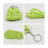A lime green thong-shaped keyring with a silver keychain, featuring textured detailing on the sole.