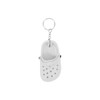A white clog shoe keyring with black accents, attached to a silver keychain.