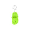 A bright green clog shoe keyring with perforations and a silver keyring attachment.