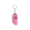 A pink clog shoe keyring hangs from a silver metal chain, featuring realistic details of a clog design.