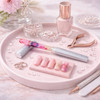 A gradient coloured glass nail file rests on a pink tray, surrounded by nail decor, polish, and beauty tools.