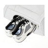 A lightweight tennis tote bag in white with a zippered compartment holding a pair of sneakers. It features a logo.