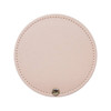 A round makeup mirror in a soft pink colour with a stitched edge and a metal button detail.