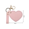 A heart-shaped compact mirror in pink, attached to a keychain with a lobster clasp and a strap.