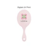 A pink handheld makeup mirror with a floral logo design in the centre.