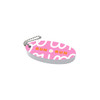 A pink oval floating keychain with a white and orange design, featuring a chain for attaching.