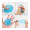 A squishy stress relief cube in various blue shades, displayed being squeezed and stretched in multiple hand positions.