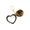 A heart-shaped acetate mirror and a small comb keyring in tortoiseshell colours. Features a metal keyring attachment.