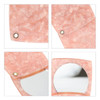 A pink acetate vanity mirror featuring a curved design and a small metal fastening. It has a reflective surface.