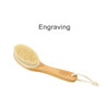 A dry brushing body brush with a wooden handle, soft bristles, and a loop for hanging. Features branding on the handle.