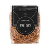A clear bag of crunchy and salted pretzels in a brown and black packaging, featuring a logo.