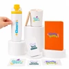 A drink bottle, candle, notebook, phone case, and stickers in various colours, displayed on white pedestals.