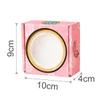 A pink custom gift box with a round window, measuring 9cm high, 10cm wide, and 4cm deep, featuring playful designs.