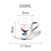 A ceramic coffee mug with a vibrant hummingbird design, silver handle, and matching saucer, measuring 250ML.