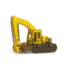 A yellow cardboard excavator model with a tracked base and a large articulated arm, featuring branding on its surface.