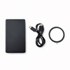 A black solid state power bank, a USB-C cable, and a circular accessory. The product features a logo.