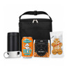 A black cooler bag containing a drink bottle, a can of ginger beer, snack mix, and gingerbread cookies.