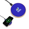 A round wireless charger in blue with a wood base, featuring a logo and a smartphone charging.