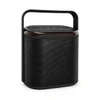 A compact black Bluetooth speaker with a handle and control buttons on the top, featuring a textured exterior.