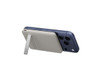 A slim, light grey power bank with a magnetic attachment on a dark blue smartphone, featuring a stand.