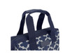 An insulated lunch bag featuring a navy and white patterned design, with sturdy handles and a branded logo.