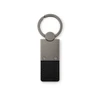 A metal keytag with a rectangular black leather strap and a circular keyring attachment.