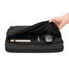 A black laptop sleeve with a zip opening, containing a notebook, pens, and a mouse inside.