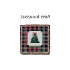 A Tapestry Blanket featuring a festive tree design surrounded by a plaid pattern in red and green with fringed edges.