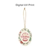 A ceramic ornament in white with festive decorations, featuring a Christmas and New Year greeting, and a gold hanging string.
