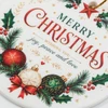 A round ceramic ornament in white, featuring festive Christmas decorations, including red and green baubles, and holly.