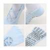 Light blue yoga toe socks with rubber grip soles and a crisscross design. Features a logo on the side.