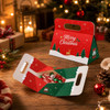A foldable gift box in red and green with festive designs, featuring a handle for easy carrying.