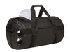 A black duffle bag rests on a surface, topped with a grey cap and a pair of sunglasses hanging from its side.