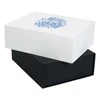 A magnetic gift box set in white and black, stacked one on top of the other, featuring a decorative design on the top.