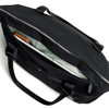 A black tote bag with an open zipper, revealing a light grey interior and a laptop inside. It features two handles and a logo.