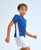 A blue and white kids' performance T-shirt worn by a child, featuring a sporty design and short sleeves.