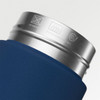 A drink bottle featuring a navy blue body and a stainless steel rim, with an embossed logo.