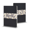 A large black Moleskine Volant journal featuring a floral design band. Includes a logo on the cover.