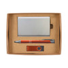 A gift set including a metallic cardholder, an orange pen, and a USB flash drive, all presented in a cardboard box.