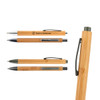 A collection of bamboo pens in various designs, featuring a clip and grey accents. One pen has a logo.