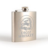 A stainless steel hip flask with an engraved eagle design, featuring a screw-top lid.