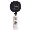 A retractable name badge holder in black with a clear strap and a circular logo attachment.