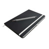 A black notebook with a white elastic band, accompanied by a gray pen resting on top.
