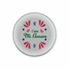 A circular speaker with a floral design in pink, green, and blue, featuring the text “Casa Mi Amore.”