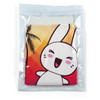A cooling towel packaged in a clear pouch featuring a cartoon rabbit design and a colorful background with palm trees.