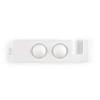 A white phone stand featuring two circular depressions and a slot for a device.